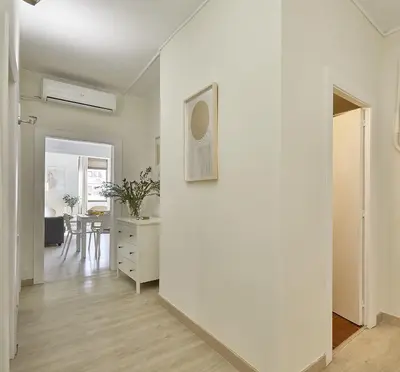 a living room with a white wall and a table at BBarcelona Encants Flat in Barcelona