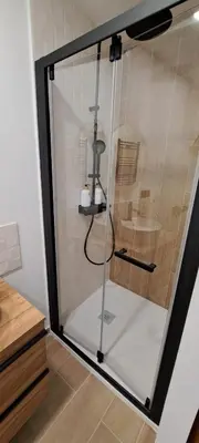 a shower with a glass door in a bathroom at SUITE Bougainvillea in Lliçà d'Amunt