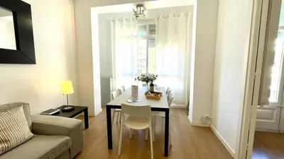 a living room with a table and a couch at Suites4days Sagrada Familia Apartment in Barcelona