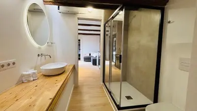 a bathroom with a sink and a glass shower at Céntrico ático by Prestigi in Terrassa