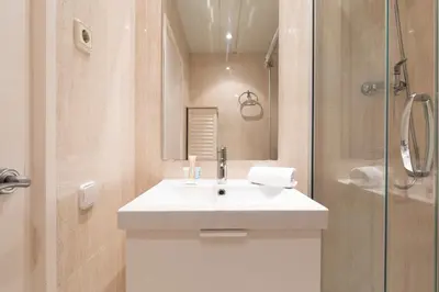 a bathroom with a white sink and a shower at AB Princep Jordi in Barcelona