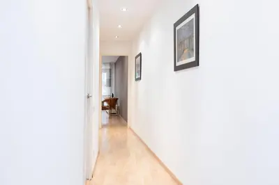 a hallway of a home with white walls and wooden floors at AB Princep Jordi in Barcelona