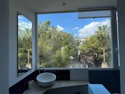a bathroom with a large window with a sink at Port Alegre Mar in Sitges