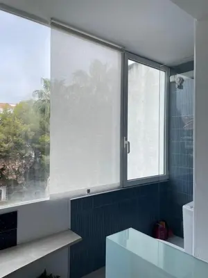 a bathroom with a large window and a sink at Port Alegre Mar in Sitges