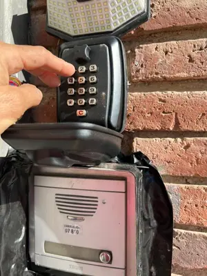 a person holding a cell phone on top of a toaster at Tessasapartments Sabadell 4 in Sabadell