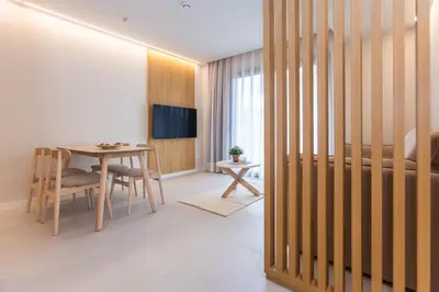a living room with a table and a dining room at Fels Apartments in Castelldefels