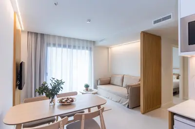 a living room with a table and a couch at Fels Apartments in Castelldefels