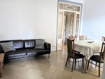 a hallway with pictures on a white wall at Centric apartment 100m from the beach in Mataró