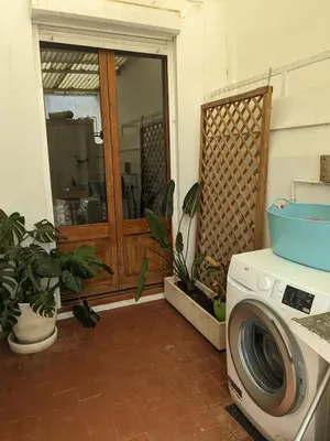 a washing machine sitting next to a door at Centric apartment 100m from the beach in Mataró