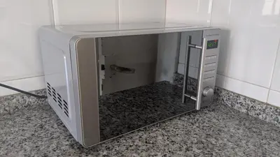 three pots and pans on a shelf in a kitchen at Centric apartment 100m from the beach in Mataró