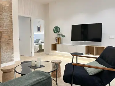 a living room with a couch and a tv at Apartment Gaudi in Vilanova i la Geltrú