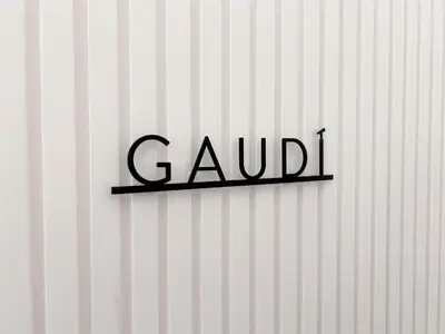 a sign on a white wall with the word gaillard at Apartment Gaudi in Vilanova i la Geltrú