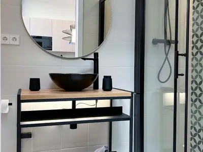 a bathroom with a sink and a mirror at Apartment Gaudi in Vilanova i la Geltrú
