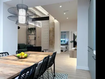 a kitchen and dining room with a table and chairs at Apartment Gaudi in Vilanova i la Geltrú