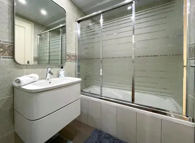 a bathroom with a tub and a sink and a shower at Apartment Monet in Vilanova i la Geltrú