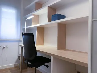 a desk with a black chair in a room at Apartment Monet in Vilanova i la Geltrú