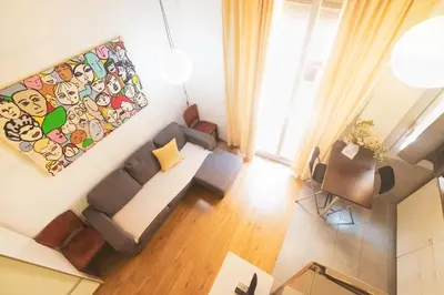 an overhead view of a living room with a couch and chairs at rentBCN Paseo de Gracia Apartments in Barcelona