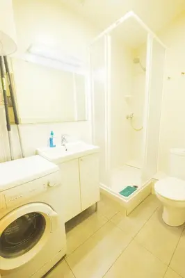 a bathroom with a washing machine and a toilet at rentBCN Paseo de Gracia Apartments in Barcelona