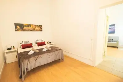 a bedroom with a bed with red pillows at rentBCN Paseo de Gracia Apartments in Barcelona