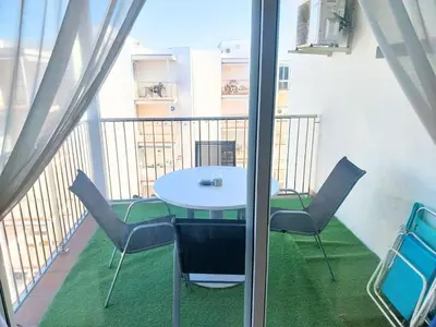 a table and chairs on the balcony of a building at Apartment by the sea in Cubelles in Cubelles