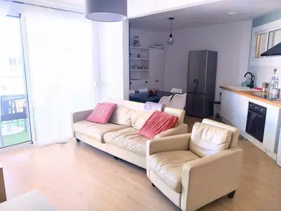 a living room with a couch and two chairs at Apartment by the sea in Cubelles in Cubelles