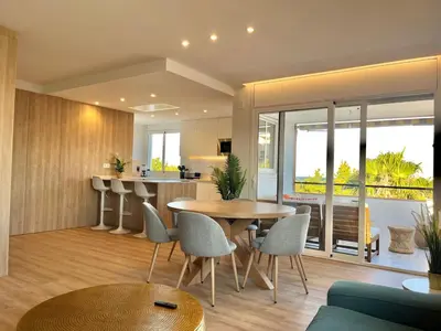 a kitchen and living room with a table and chairs at Atico Barcelona Playa in Sant Adria de Besos