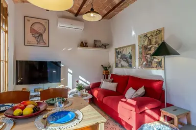 a living room with a red couch and a table at 2088 - AB Sagrada Familia in Barcelona
