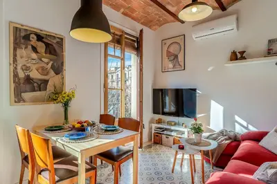 a living room with a table and a red couch at 2088 - AB Sagrada Familia in Barcelona