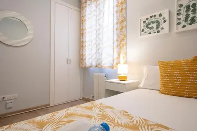a bedroom with a bed and a window at Alcam Mallorca 22 in Barcelona