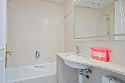 a bathroom with a sink and a mirror and a tub at Alcam Mallorca 22 in Barcelona