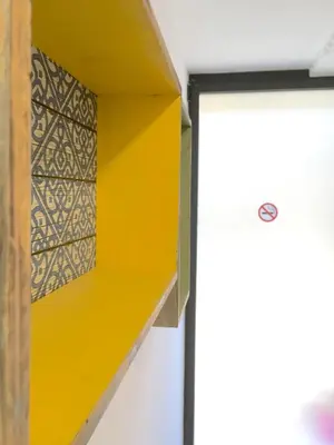 a yellow shelf in a room with a door at Ant Hostel Barcelona in Barcelona