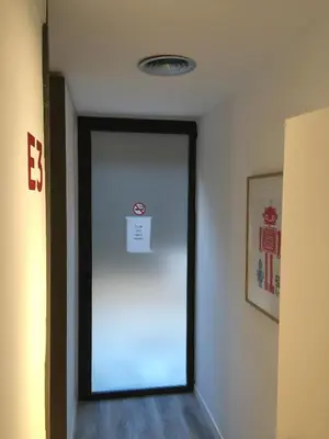 a hallway with a door with a sign on it at Ant Hostel Barcelona in Barcelona