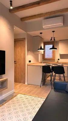 a kitchen and living room with a table and chairs at La Fira - Paralelo 2 in Barcelona