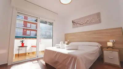 a bedroom with a bed and a large window at SeaHomes Vacations - Villa Chill & Pool 200m Beach in Pineda de Mar