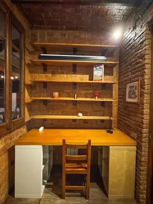 a dining room with a wooden table and chairs at Unique central home with large terrace & pool in Barcelona
