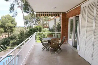 a patio with a table and chairs on a balcony at Apartamentos Villa Valle in Castelldefels