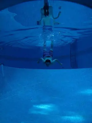 a person swimming in a pool in the water at Apartamentos Villa Valle in Castelldefels