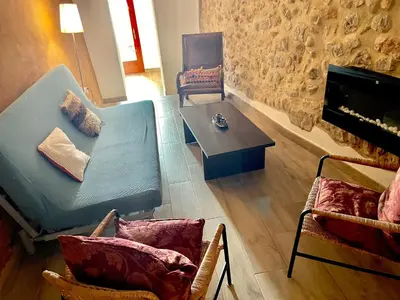 a living room with a couch and a table at Old Town Montserrat in Collbató