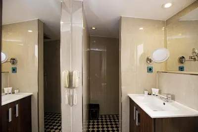 a bathroom with two sinks and a shower at luminous top floor apartment with terrace in Barcelona