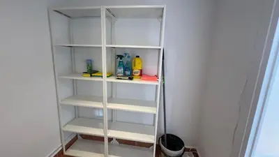 a white closet with white shelves in a room at Piso Centro Badalona in Badalona