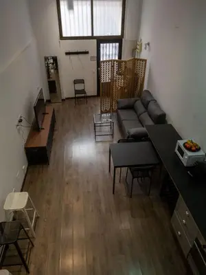 a living room with a couch and a table at Casa Gracia con Jardín in Barcelona