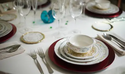 a table with plates and a coffee cup on it at Hotel Boutique Edelweiss La Garriga in La Garriga