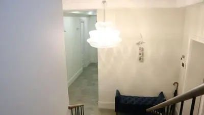 a hallway with a blue couch and a chandelier at Casa o chalet independiente en venta en Sarrià in Sant Just Desvern