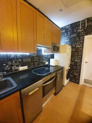 a kitchen with a black wall with writing on it at Barcelona RAVAL Y ROQUETES in Hospitalet de Llobregat