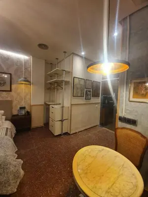 a living room with a table and a room with at Barcelona RAVAL Y ROQUETES in Hospitalet de Llobregat