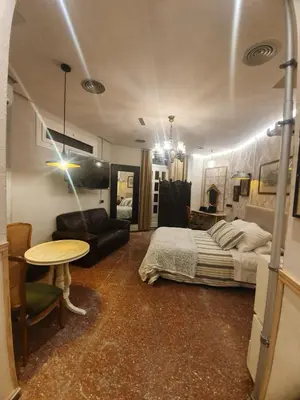 a bedroom with a bed and a table in it at Barcelona RAVAL Y ROQUETES in Hospitalet de Llobregat