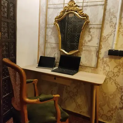 two laptops sitting on a desk with a mirror at Barcelona RAVAL Y ROQUETES in Hospitalet de Llobregat