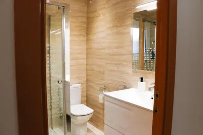 a bathroom with a toilet and a sink and a mirror at Cozy Apartment Rocamar in Sant Pere de Ribes