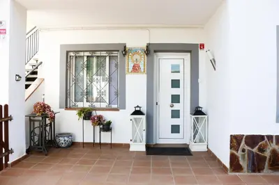 a white house with a white door and a staircase at Cozy Apartment Rocamar in Sant Pere de Ribes