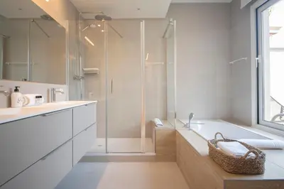 a bathroom with a shower and a tub and a sink at Ático dúplex con cinco dormitorios in Barcelona